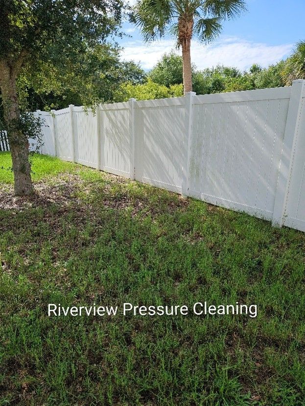 Paver patio and vinyl fence with dirt, weeds, algae, and mildew buildup in Gibsonton