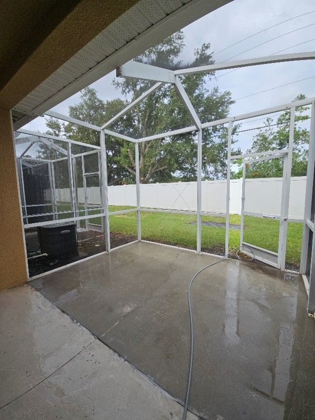 Clean lanai in Panther Trace Riverview after pressure washing the cage, screens, and concrete, ready for new tenants.