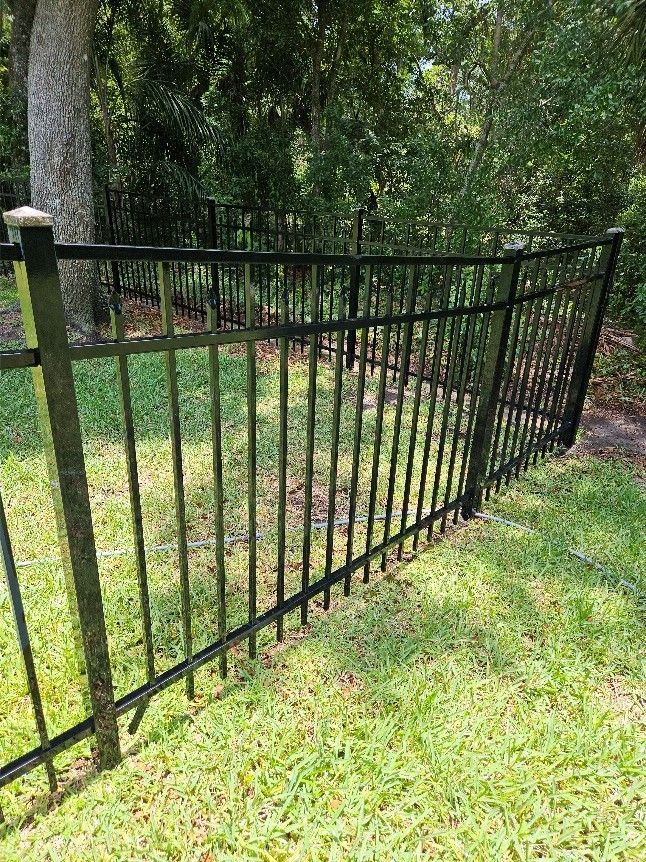 Clean wrought iron picket fence in Brandon after professional fence pressure washing before repainting