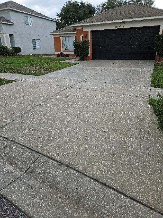 Dirty driveway with algae and mildew before driveway pressure washing in the Summerfield neighborhood of Riverview FL.