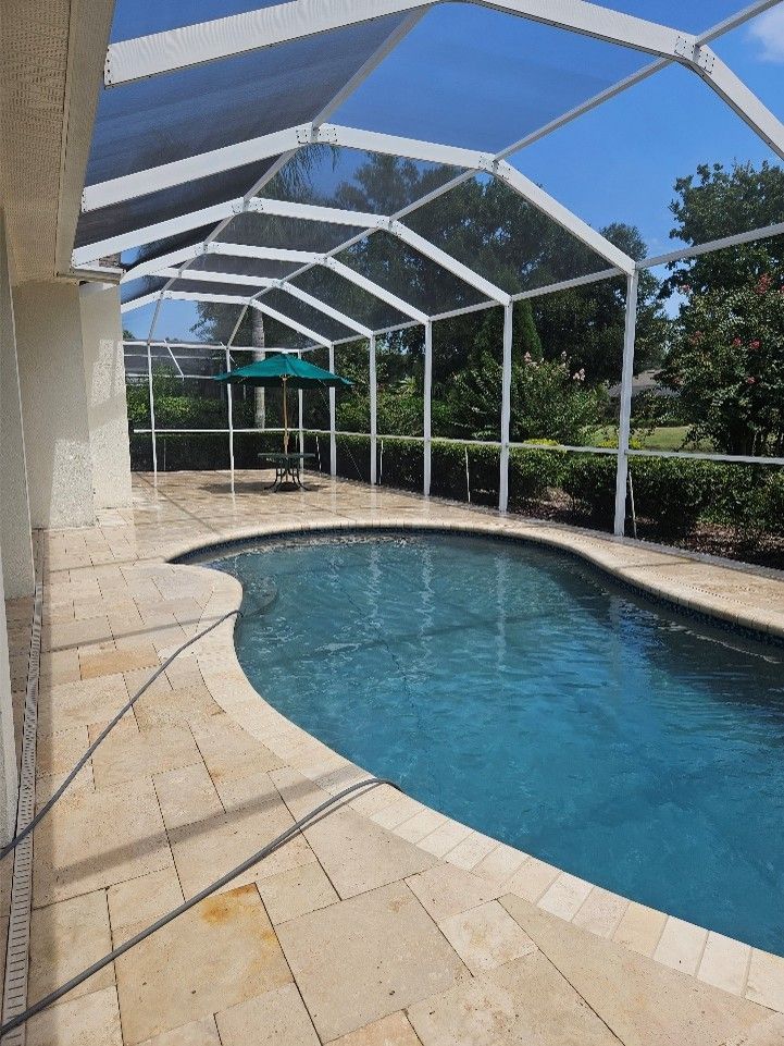 Pool cage, screens, and pool deck covered with algae, mold, and pollen before pressure washing in Valrico.