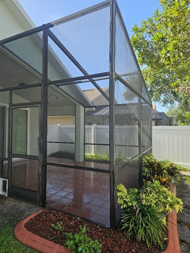 Clean screened lanai with washed cage, screens, and tile deck after pressure washing in Riverview.