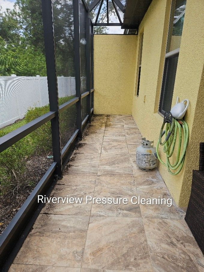 Lanai in Apollo Beach with dirt dust and pollen covering the screens cage and tile floor before pressure washing.
