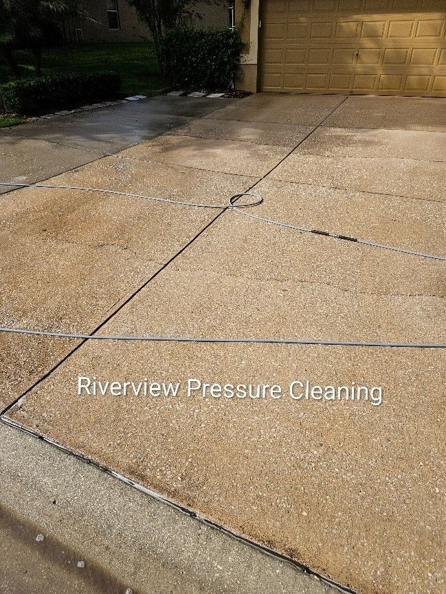 Dirty driveway and sidewalks with algae and mildew before driveway pressure washing in Woodberry Brandon FL