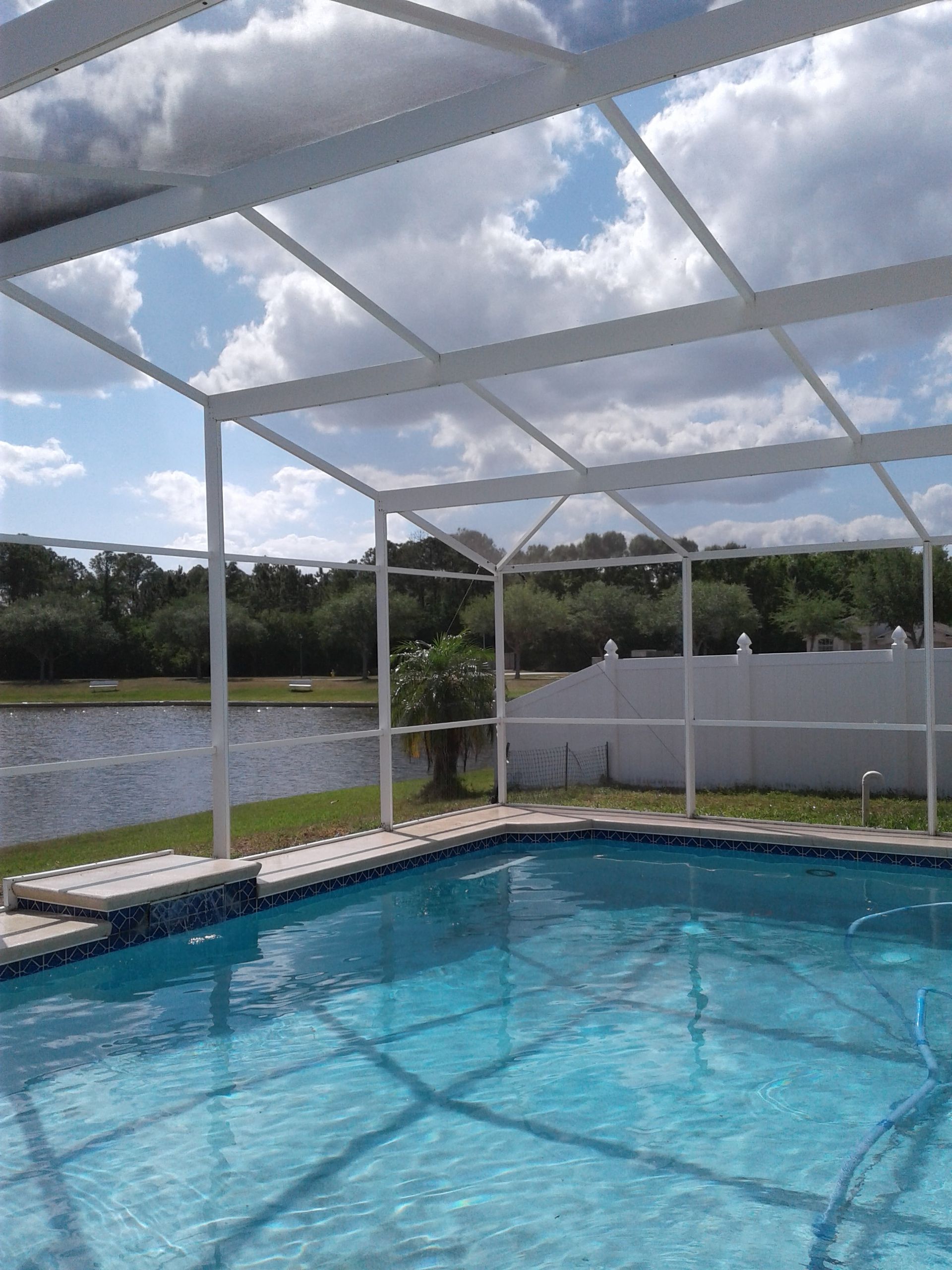 Homeowner cleaning pool cage screens
