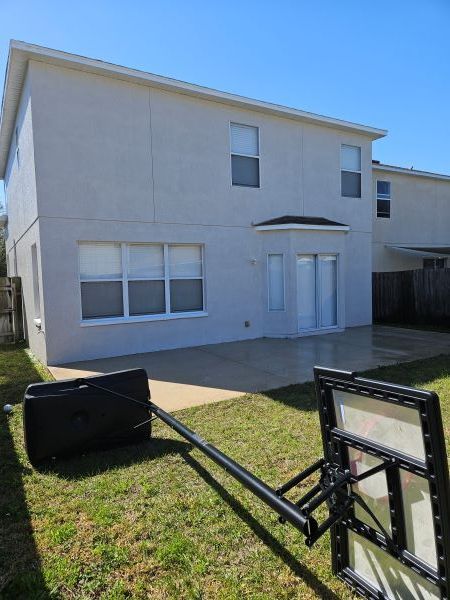 A house with a basketball hoop in front of it