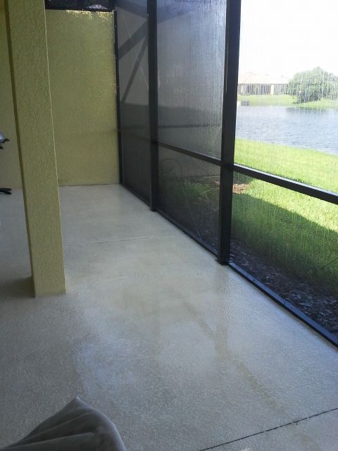 A screened in porch with a view of a lake