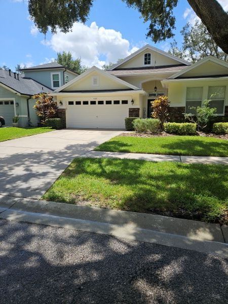 Driveway pressure washing in Lithia, FL to remove dirt, mold and algae to comply with HOA notice