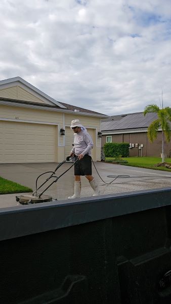 Using a surface cleaner to pressure wash a driveway in Apollo Beach, FL
