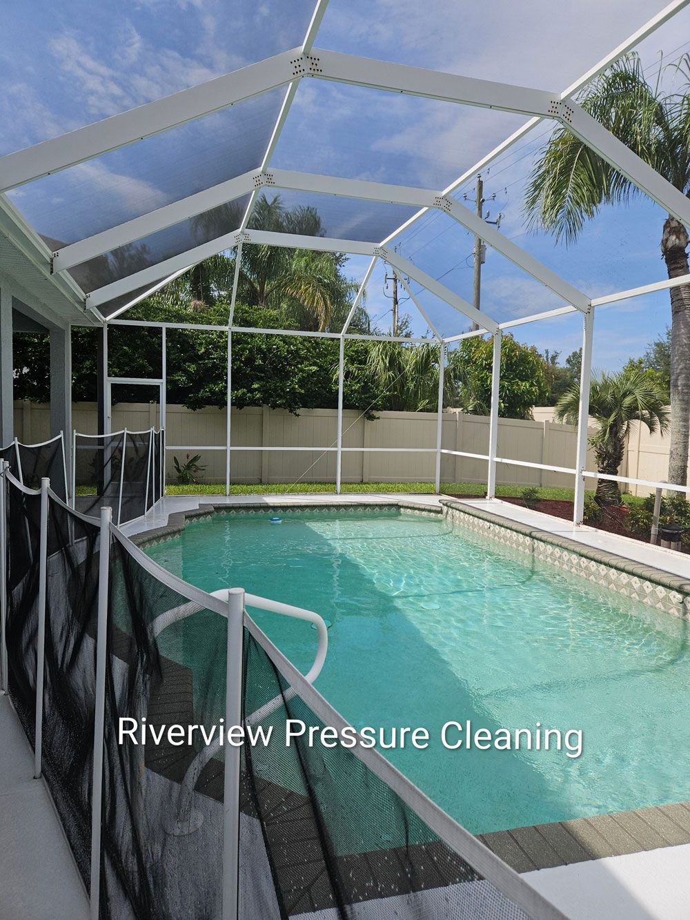 Clean pool cage, sparkling screens, and freshly washed painted pool deck after pressure washing in Riverview