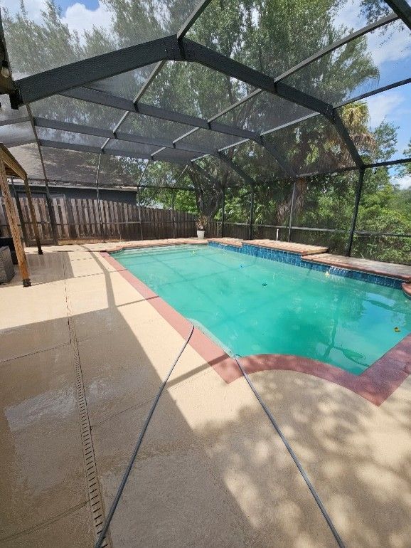 Pool cage cleaning in Brandon FL restoring screens and pool deck