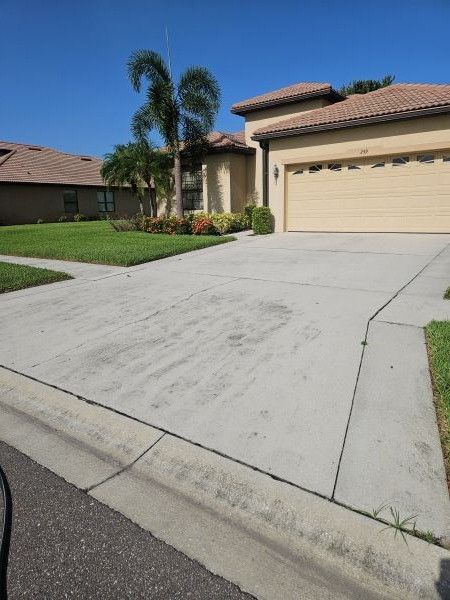 Driveway before pressure washing showing algae and dirt buildup