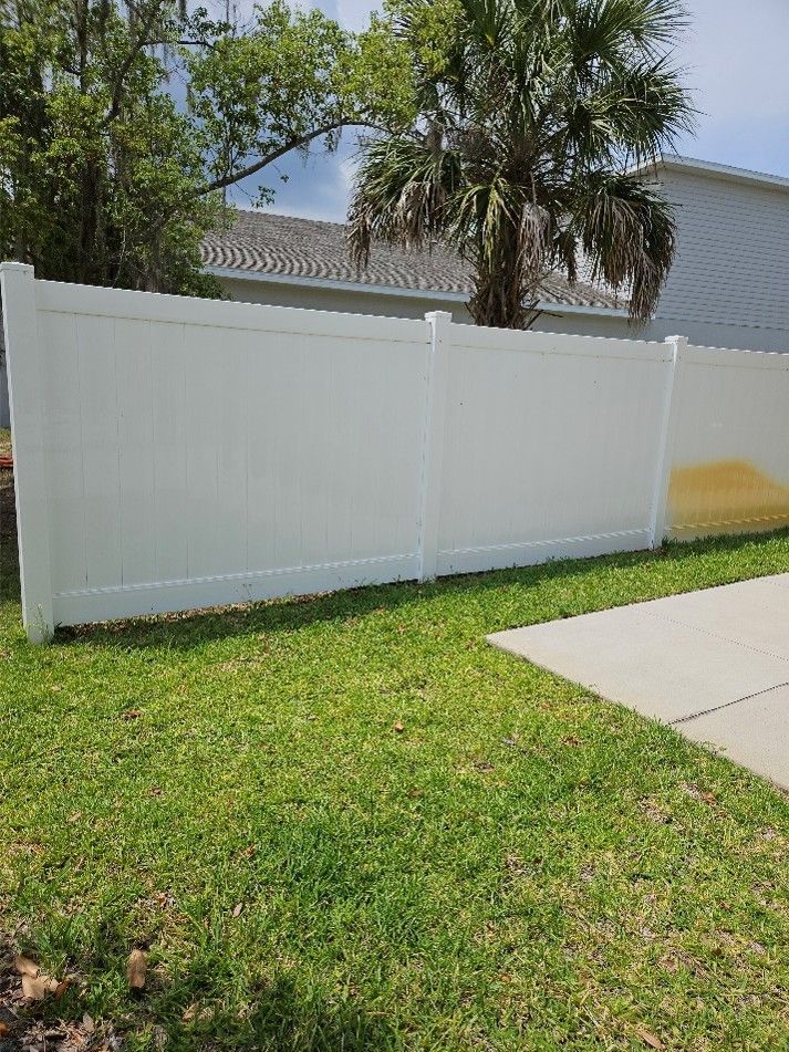 Fertilizer and iron staining on a white vinyl fence