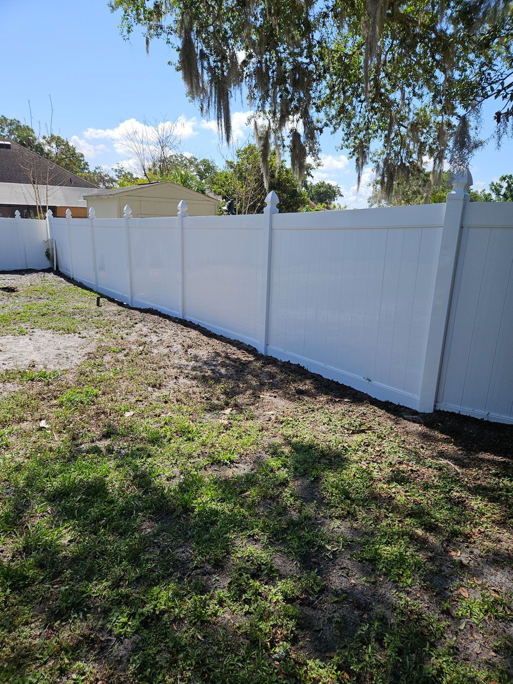 Clean white vinyl fence after pressure washing in Valrico, FL