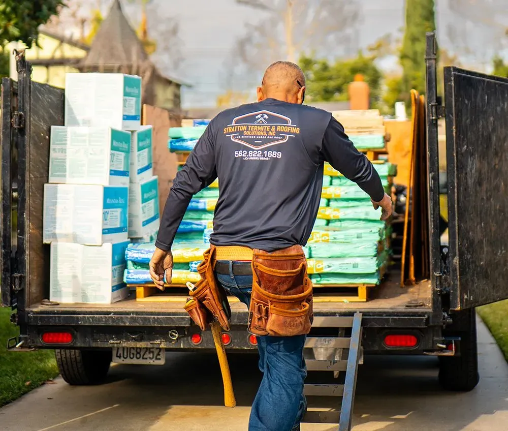 A man is standing in front of a truck full of boxes A man is standing in front of a truck full of boxes