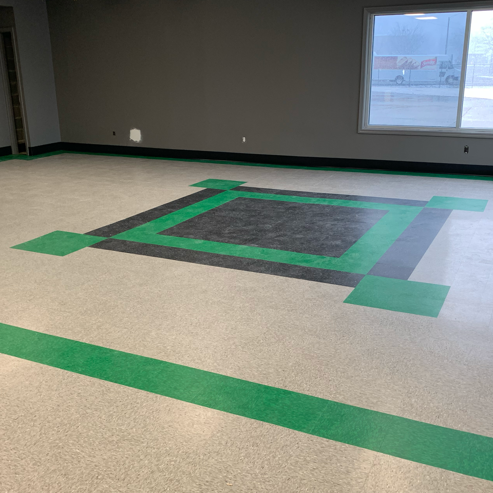A room with a green stripe on the floor