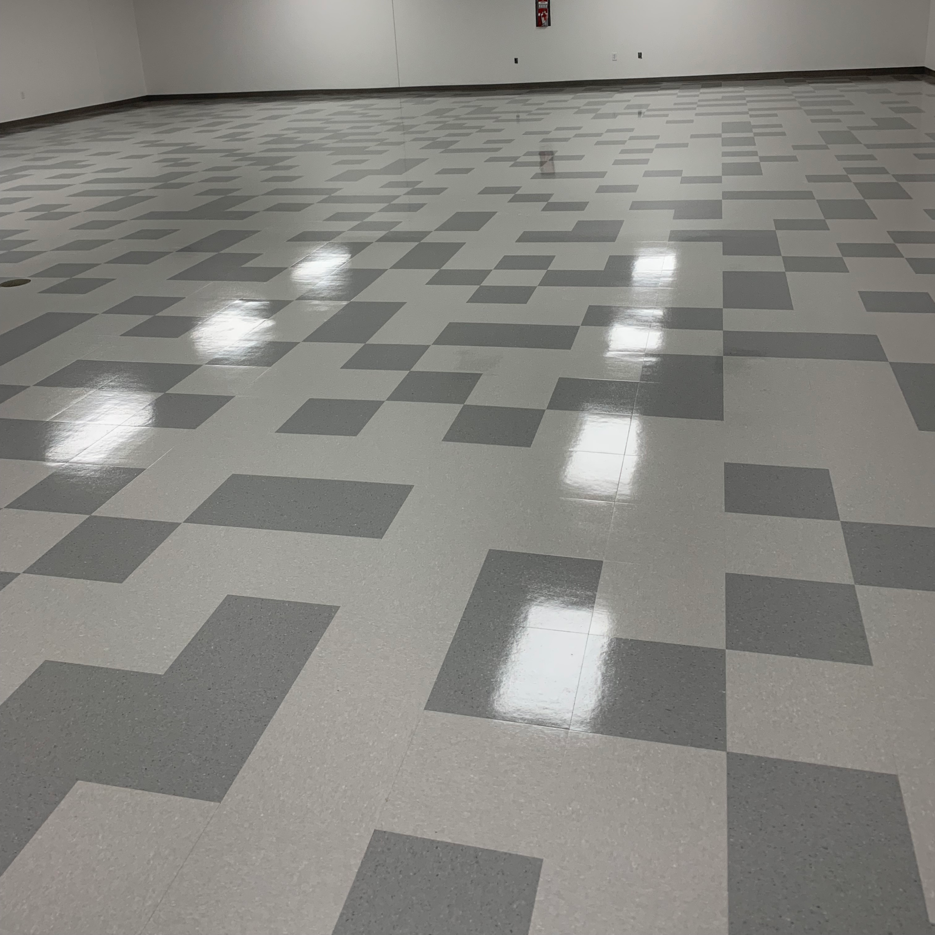 A large room with a checkered floor and white walls