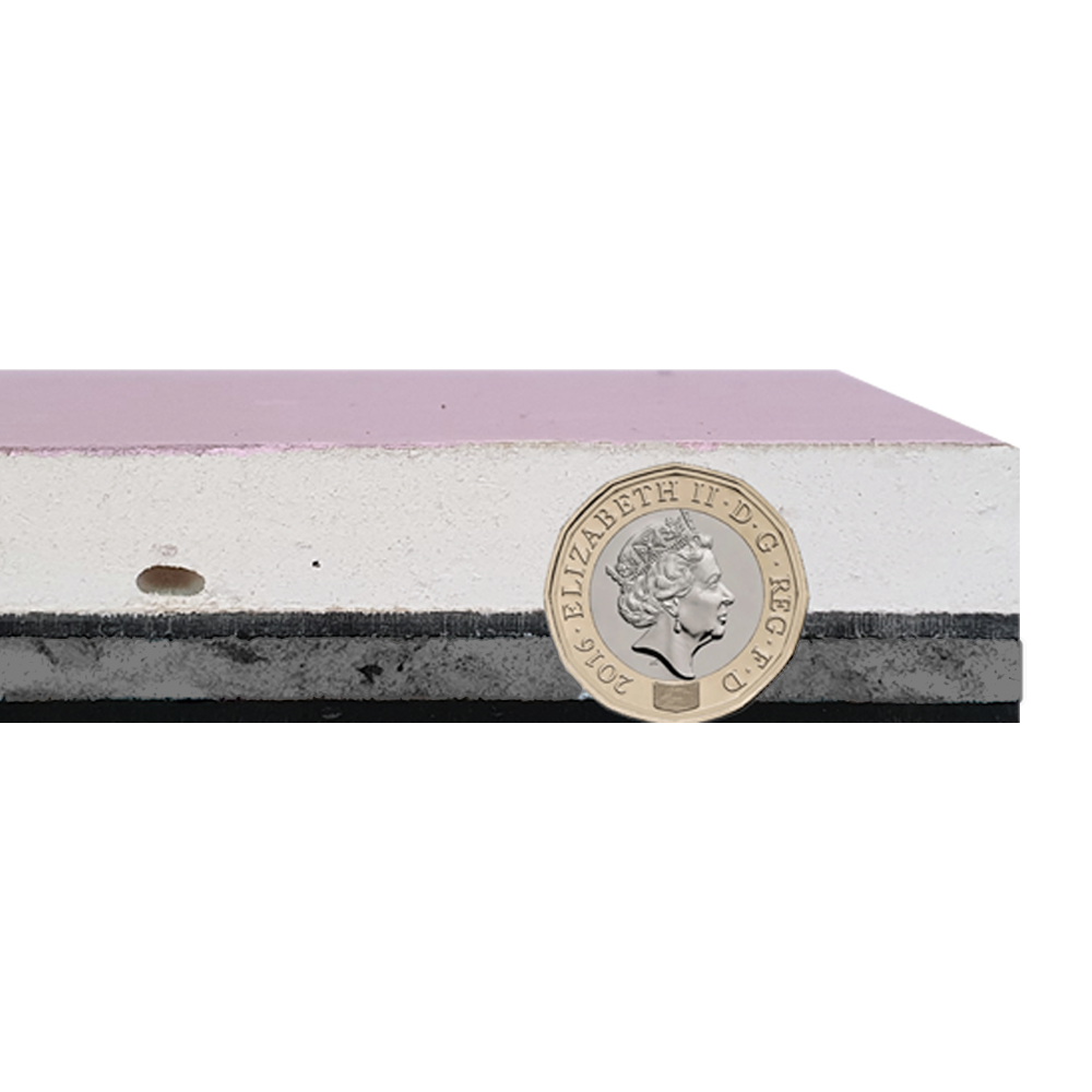 A pound coin is sitting on top of a piece of drywall.