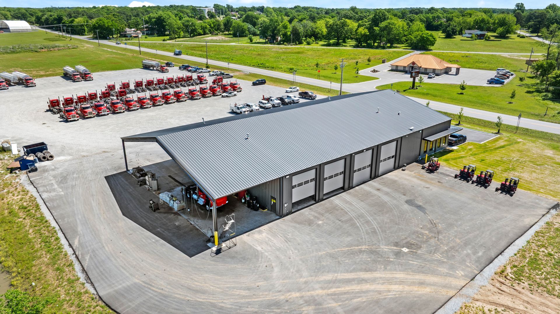 Drone view of a gray metal commercial shop building manufactured by Quality Metal Building Systems
