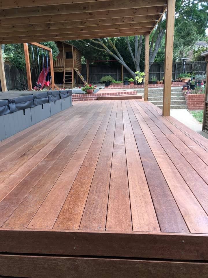 Wooden deck with pergola, overlooking backyard with playset and brick patio — MGP Landscaping in Geelong, VIC