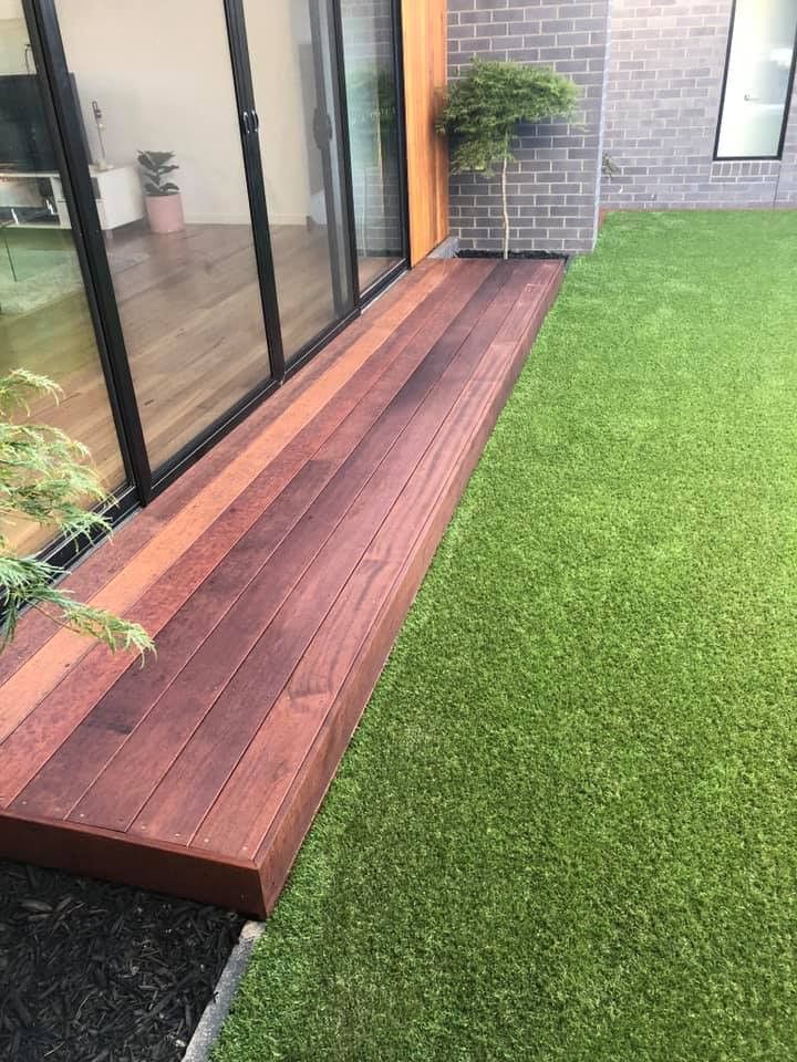 Wooden Deck Next to Sliding Glass Doors and Green Lawn — MGP Landscaping in Geelong, VIC