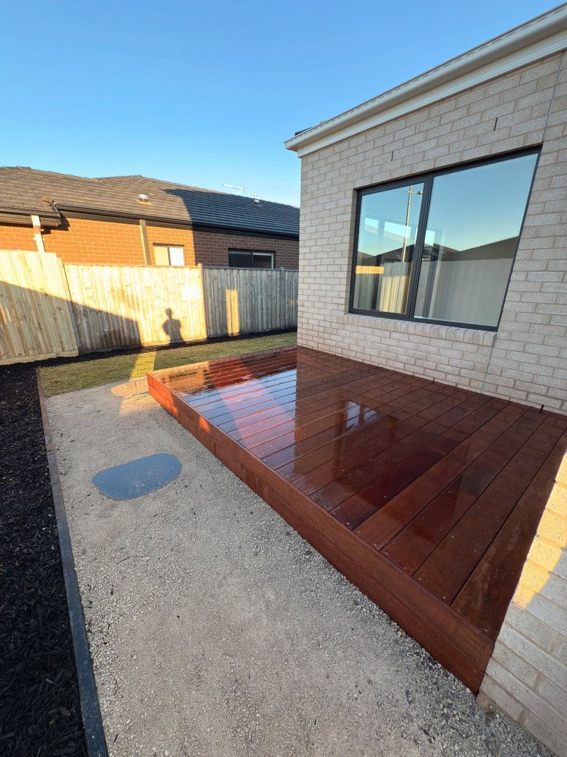 Wooden Deck Next to A Brick Building. Gravel Path Leads to The Deck — MGP Landscaping in Geelong, VIC