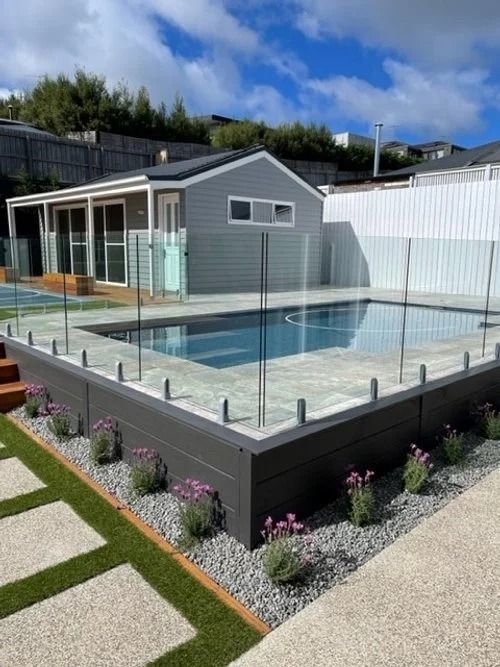 Swimming Pool with Glass Fencing, Grey Wood Surround — MGP Landscaping in Geelong, VIC