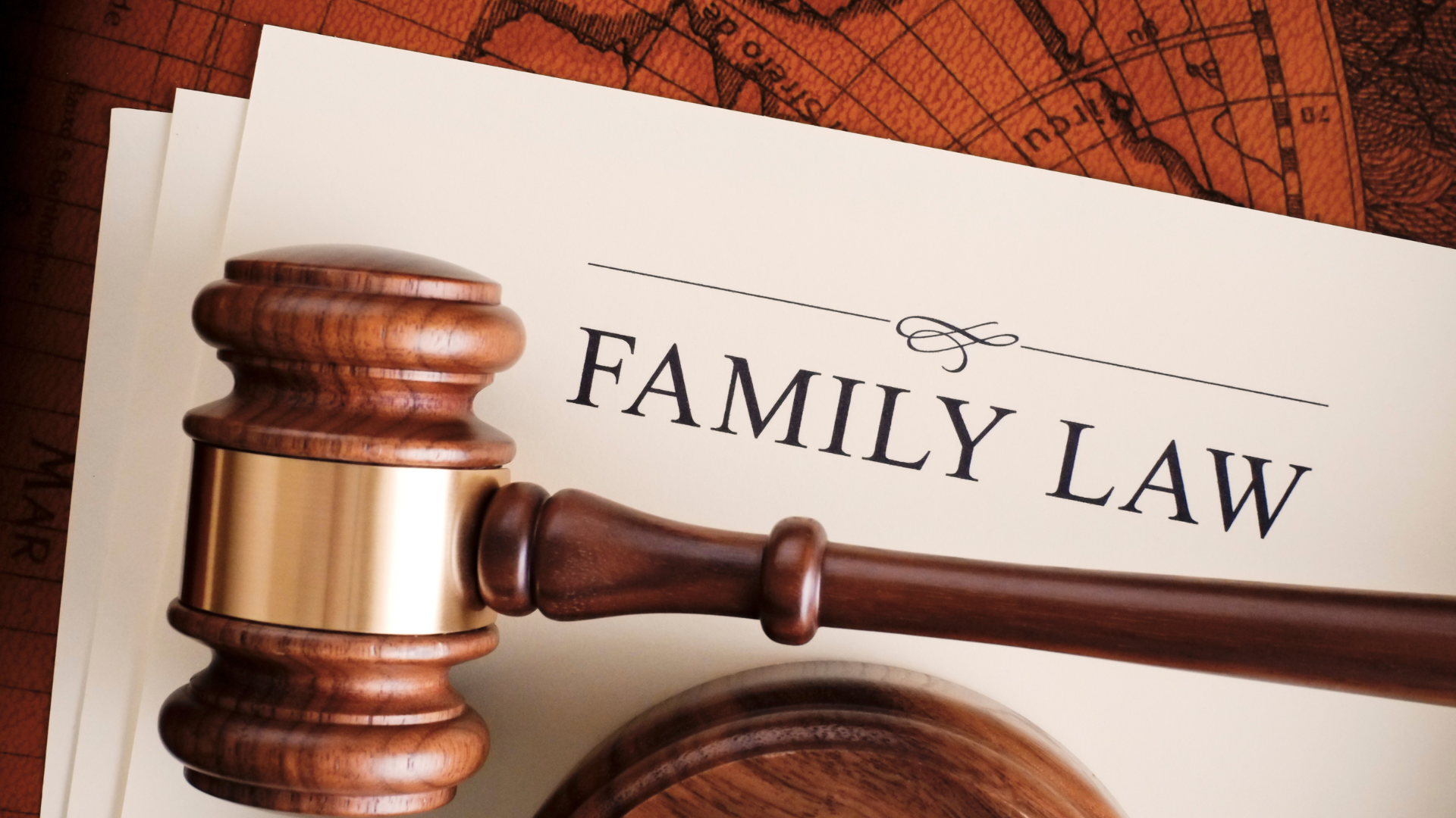 Family law gavel over a document, with courtroom-themed background.