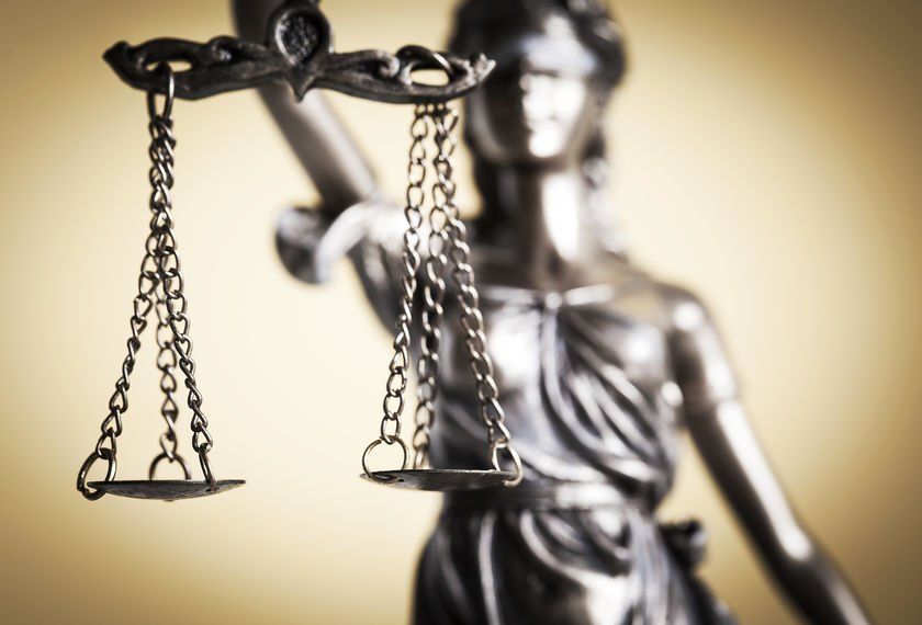 A statue of lady justice holding a pair of scales