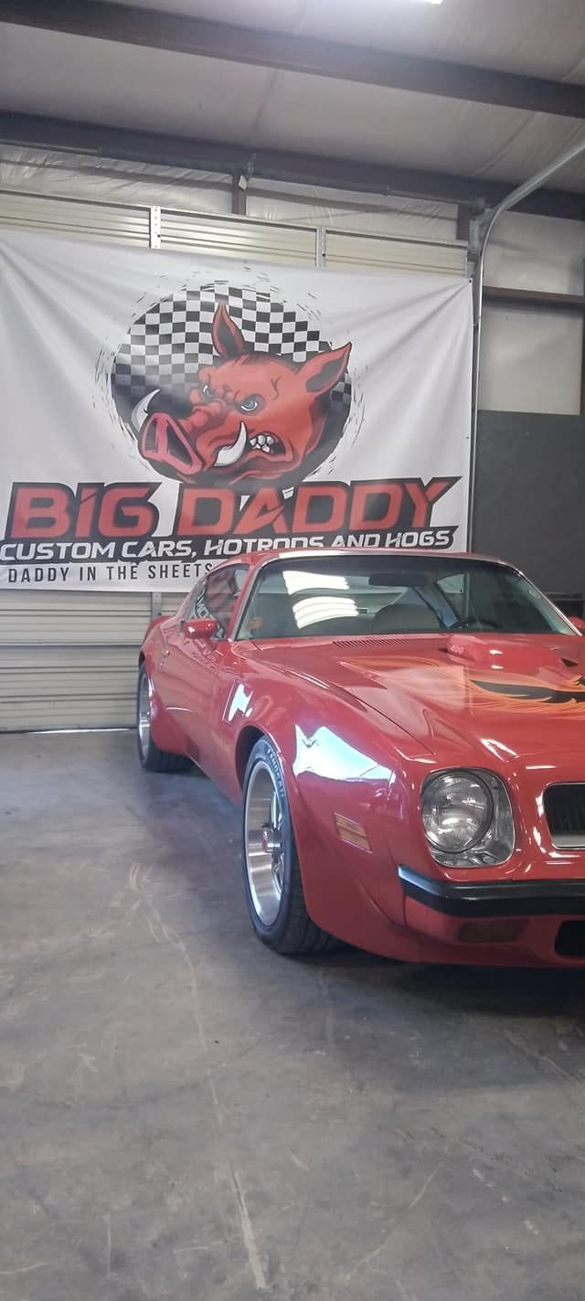 red sports car in the Big Daddy Customs shop