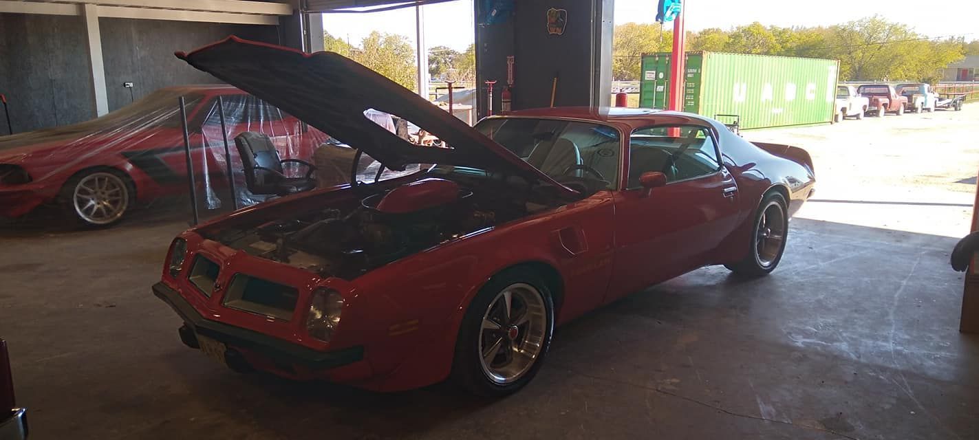 red sports car with hood open