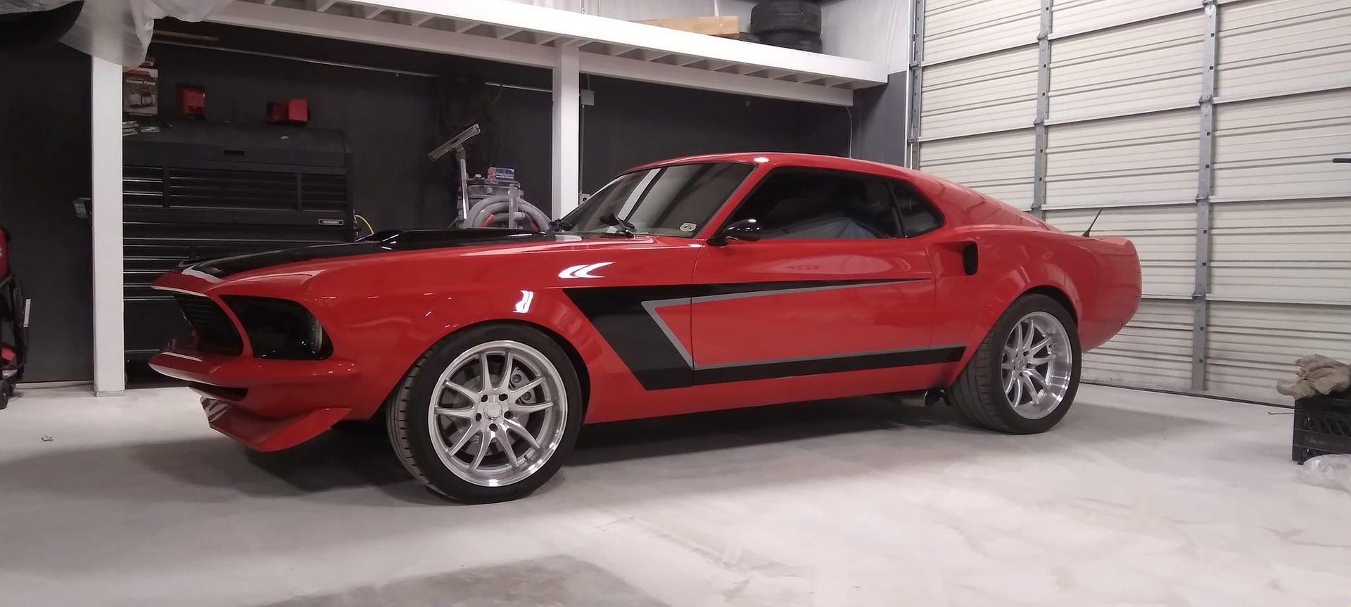 red sports car in the Big Daddy Customs shop