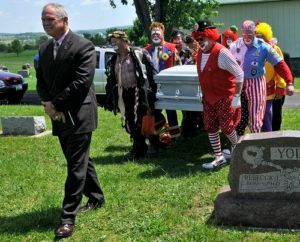 People dressed up as clowns carrying casket saying goodbye to loved one at Torres Cremation and Burial Services CA