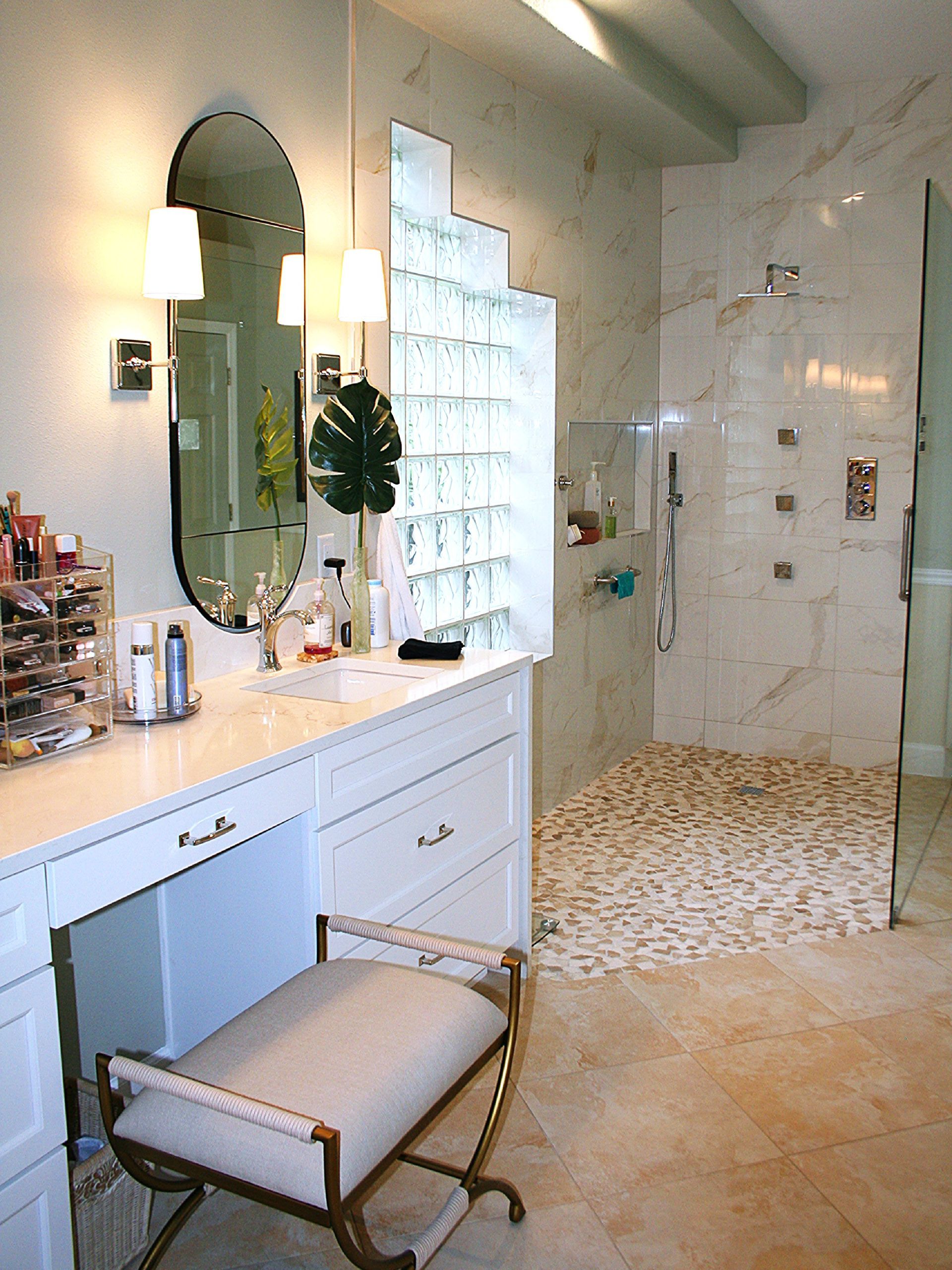 Modern white bathroom with vanity, mirror, tub, and mosaic tile floor