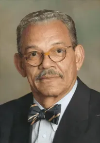 Man wearing glasses, bow tie, and suit jacket, looking at the camera. Man wearing glasses, bow tie, and suit jacket, looking at the camera.