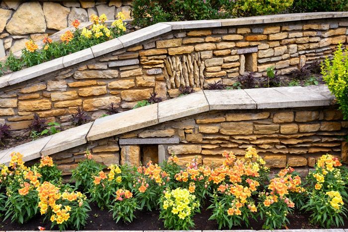 Retaining walls and flowerbeds in house backyard. Retaining walls and flowerbeds in house backyard.