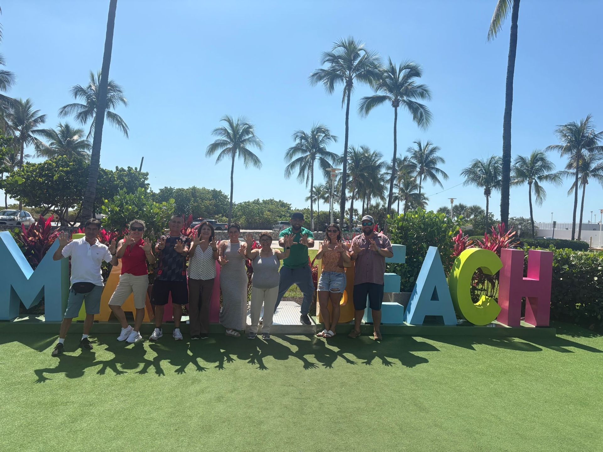 Passengers ad tour guide in Miami Beach, first hop on hop off stop in the Miami 5 in 1 Bus tour