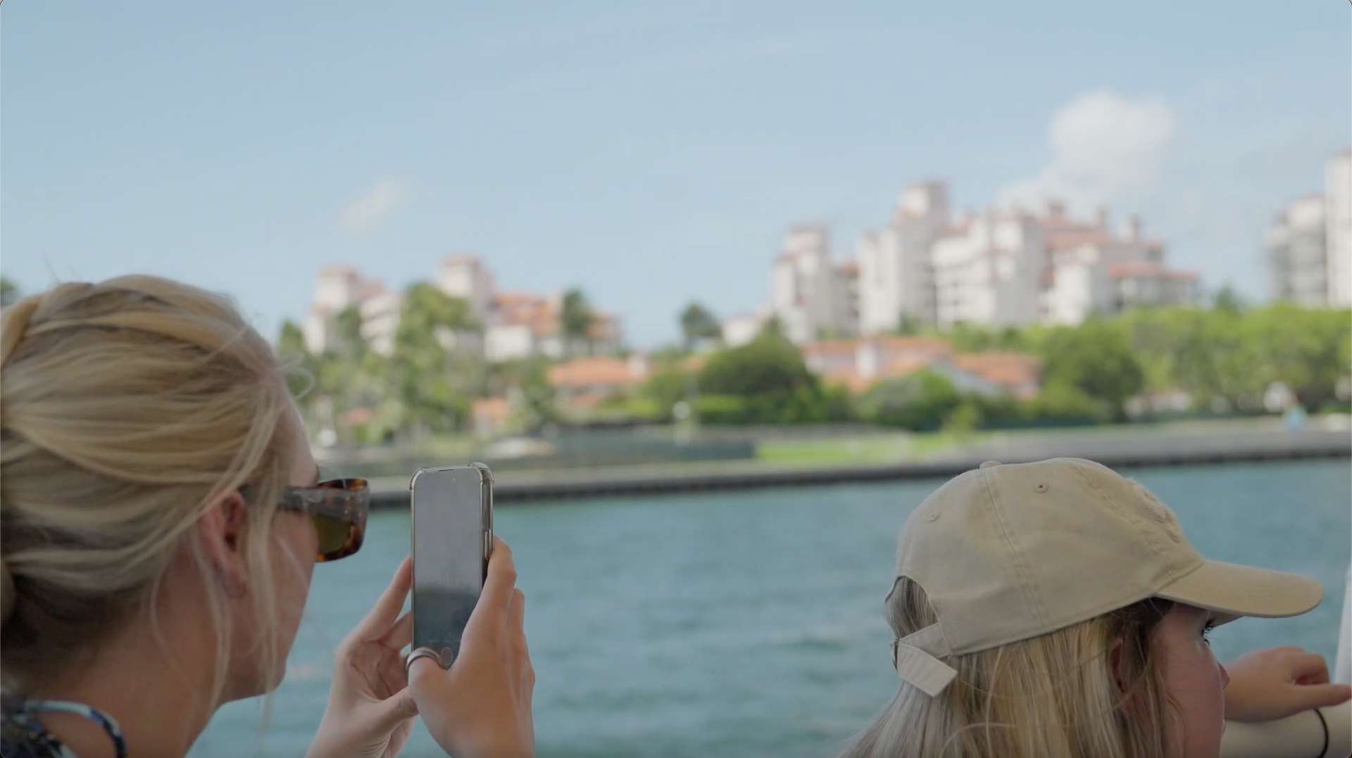 Guest taking photos of Fisher island on the Boat tour in Miami