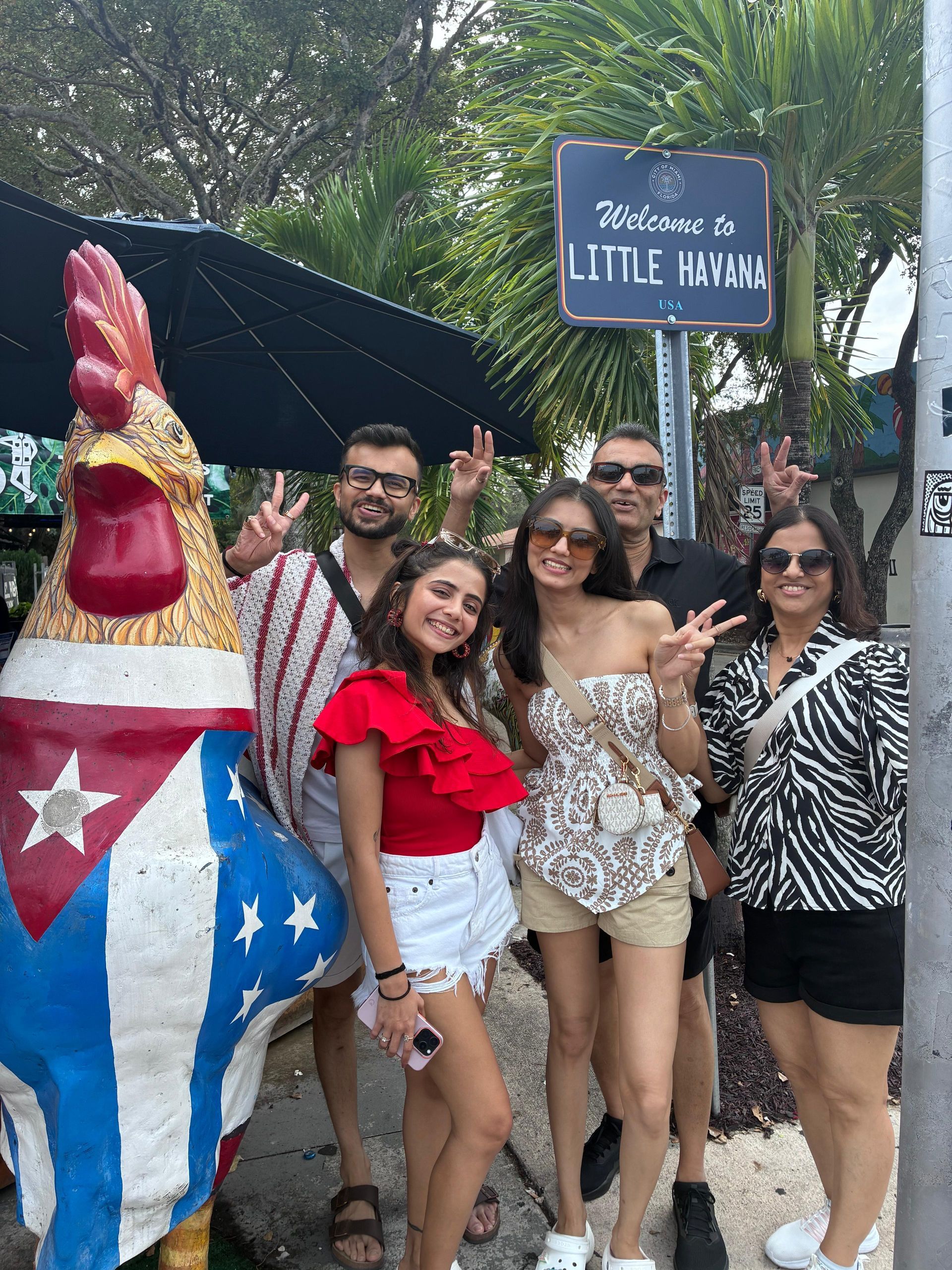 Group of guests posing at the Little Havana stop during a Hop On Hop Off Miami bus tour.
