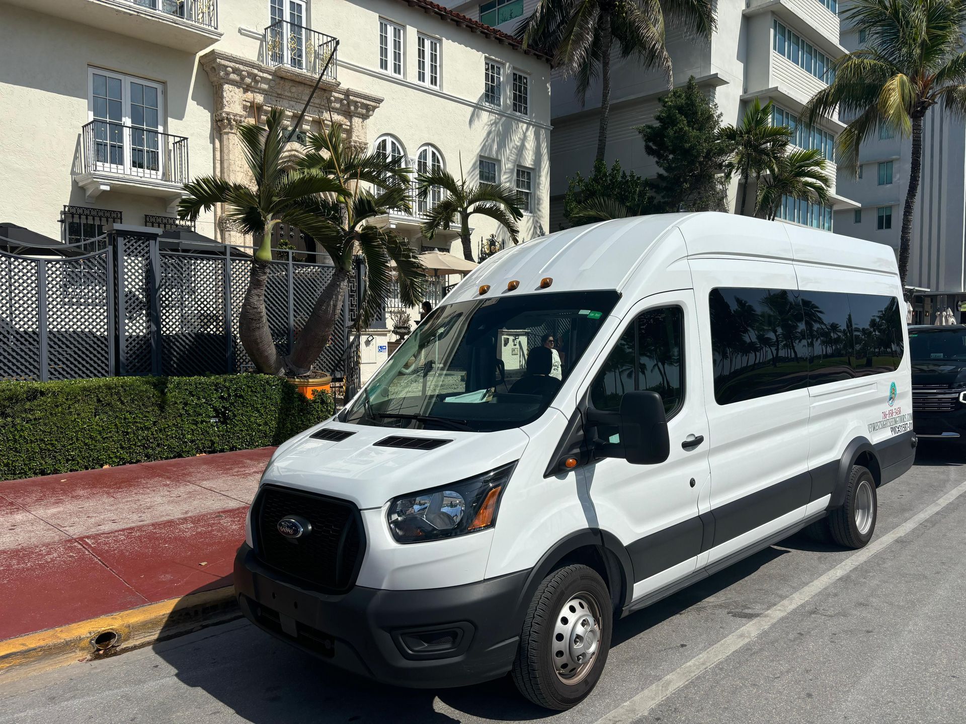 Sightseeing hop on hop off bus parked in front of the Versace Mansion