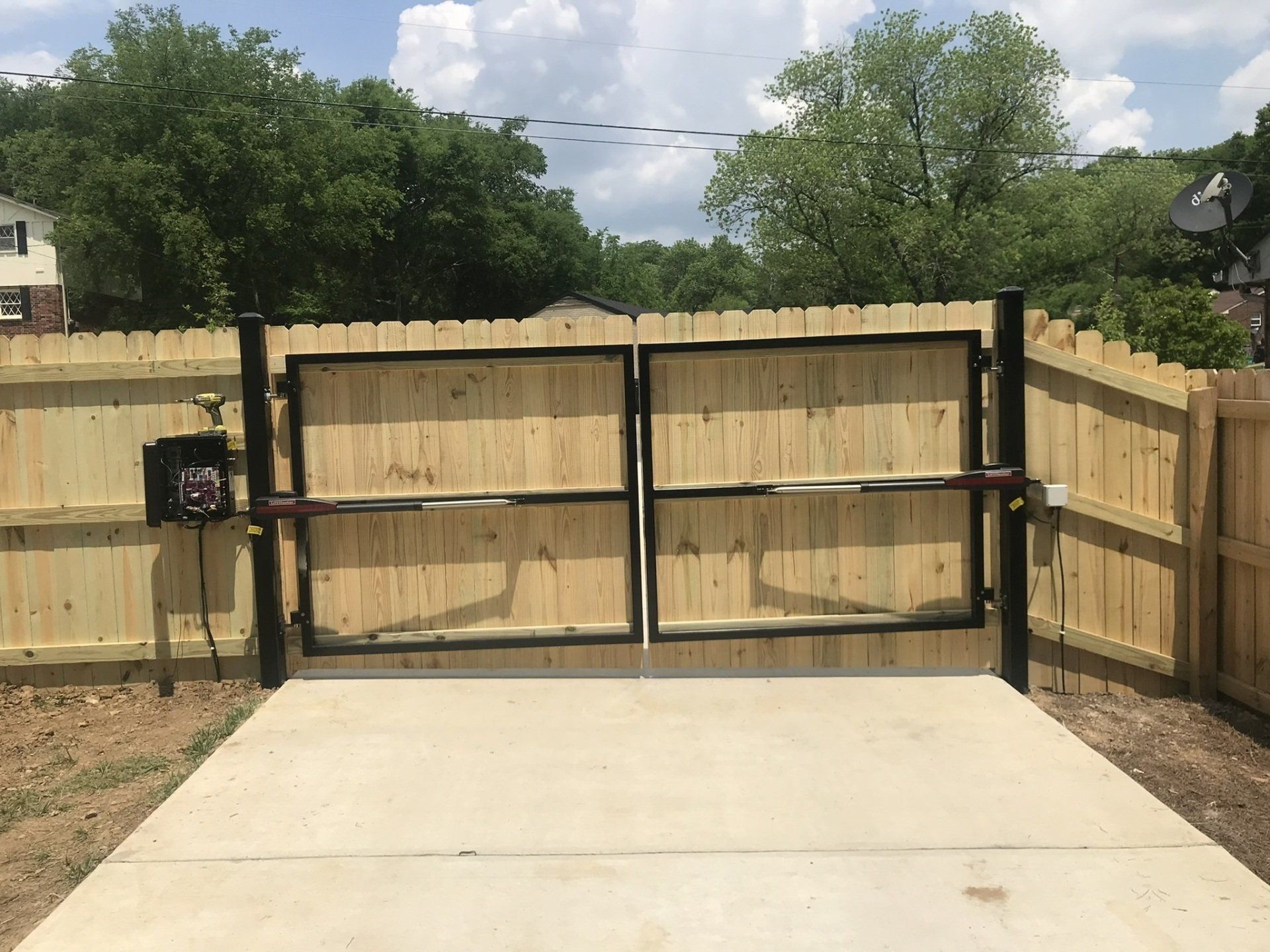 a wooden fence with a gate in the middle of it
