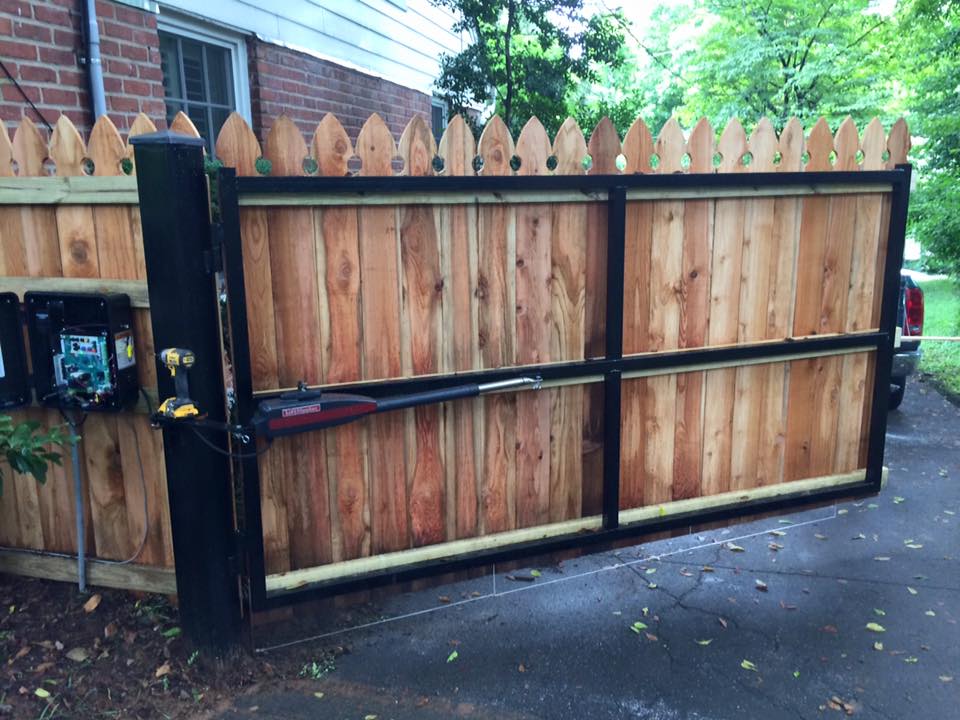 a wooden fence with a mailbox in front of it
