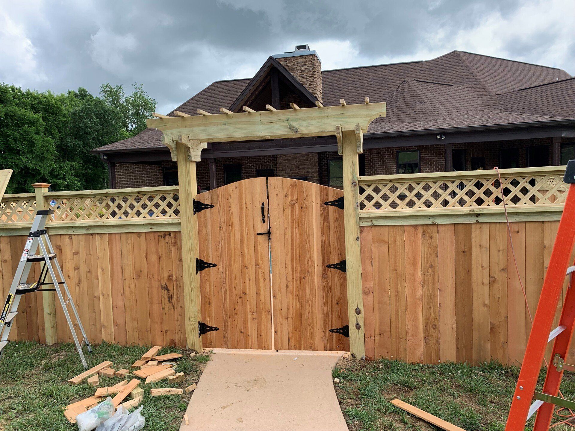 a wooden gate is being built in front of a house .