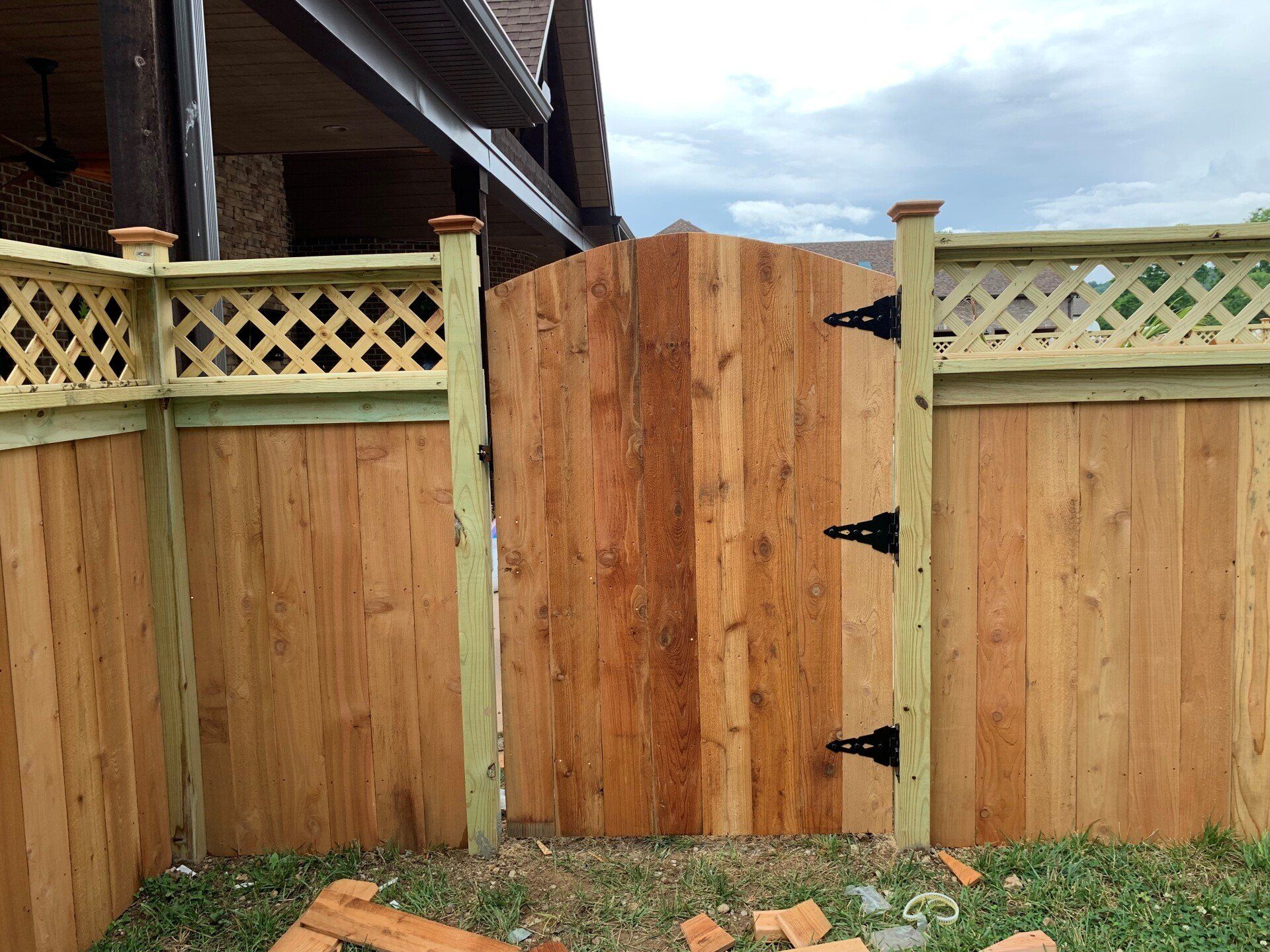 a wooden fence with a gate in the middle of it