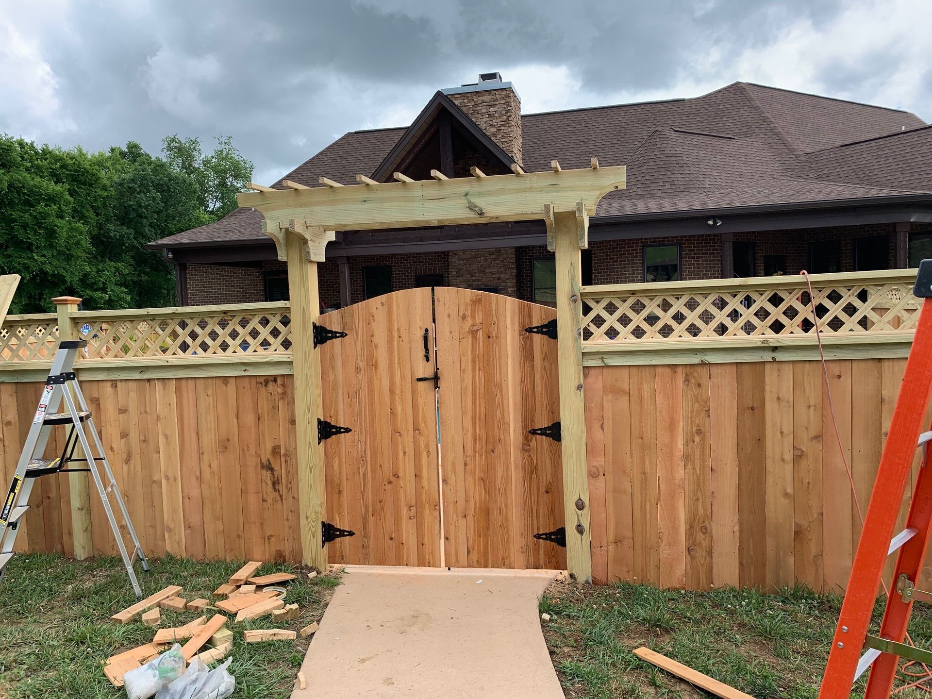a wooden gate is being built in front of a house .
