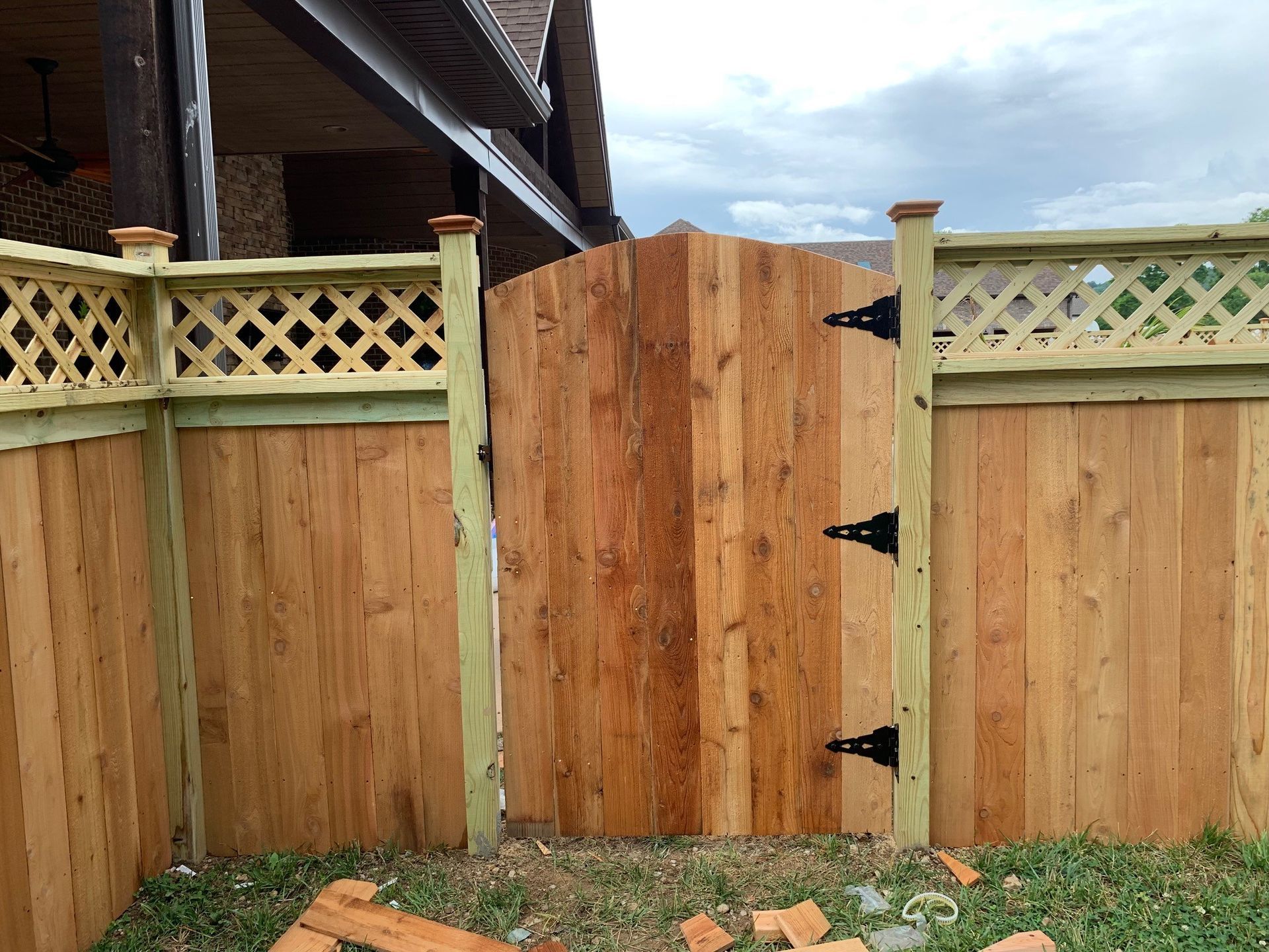 a wooden fence with a gate in the middle of it