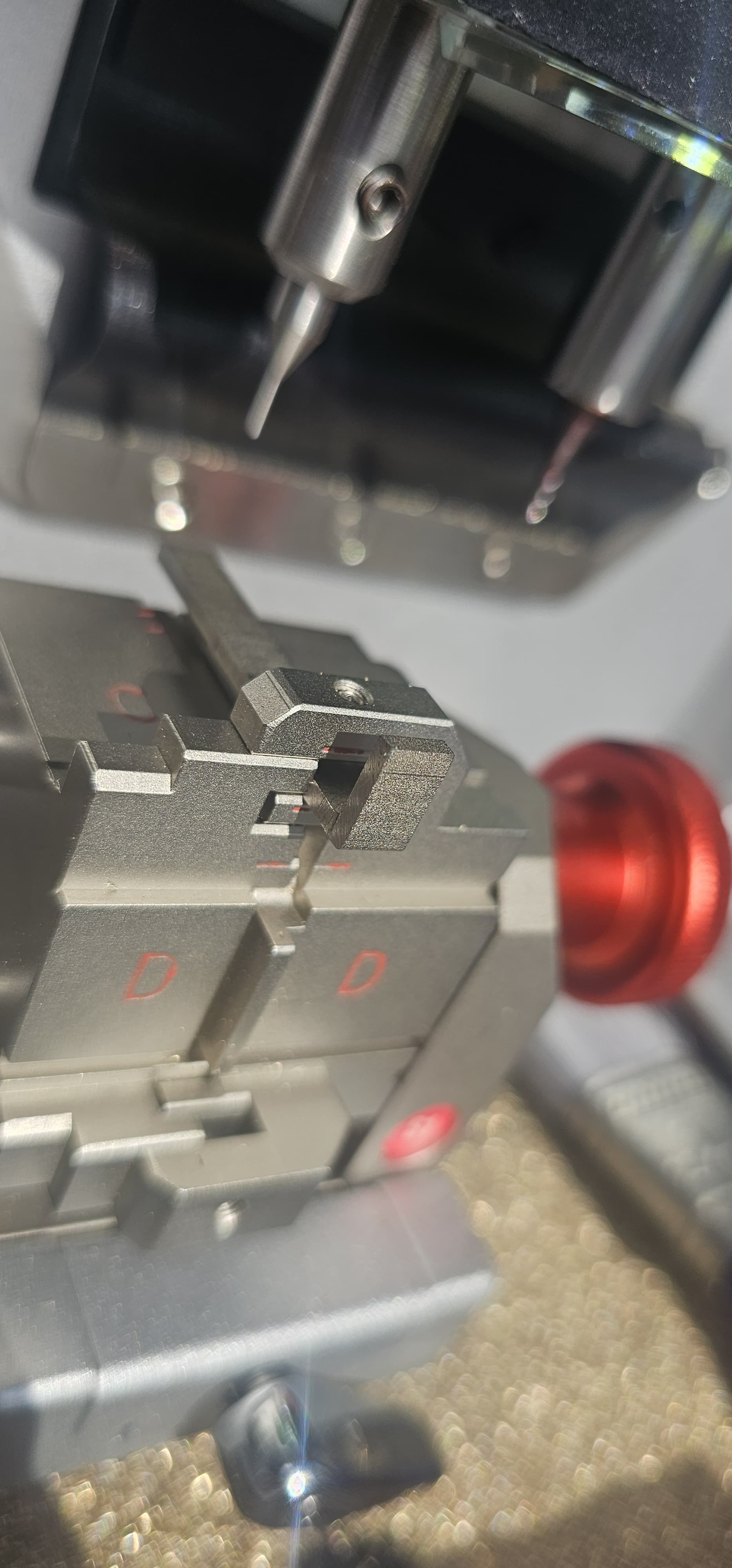 A close up of a machine with a red button on it.