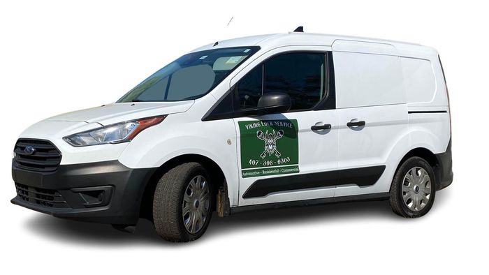 A white van with a green sign on the side is on a white background.