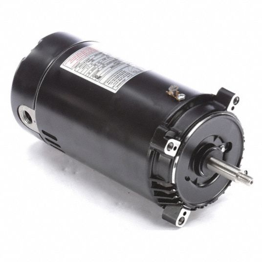 A close up of a black motor on a white surface