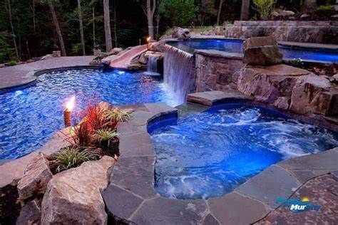 There is a waterfall in the middle of the pool.